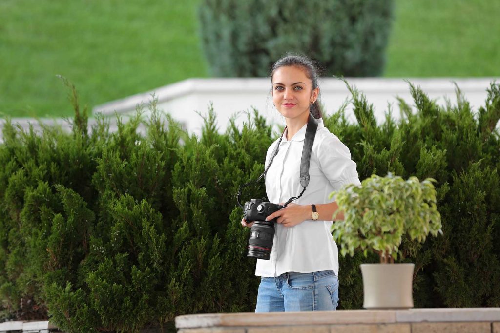 A female photographer covering a wedding event