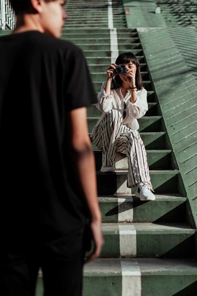 A woman taking a photography using a film camera